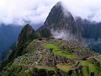 Machu Picchu ruins surrounded by mist-shrouded granite peaks Machupicchu ruins